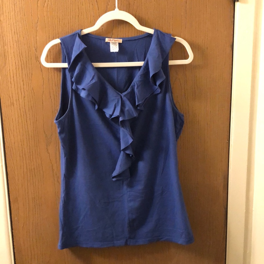Sleeveless blouse, with ruffles down the front.
